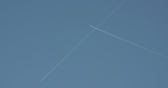 A Distant Airplane Passes High Overhead