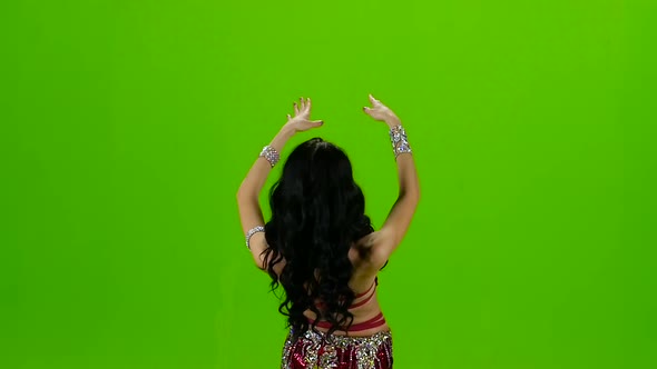 Woman Standing Back in Costume with Ornaments Dancing Belly Dance. Green Screen. Slow Motion alt