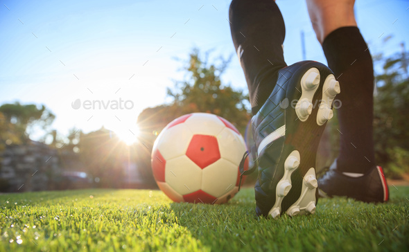Woman and a soccer ball on the grass - Stock Photo - Images