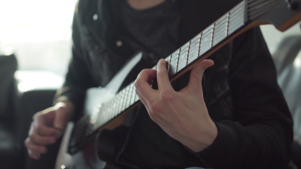 Man Playing on an Electric Guitar alt