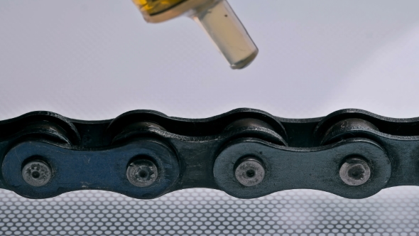 Man Lubricates the Chain from the Syringe alt