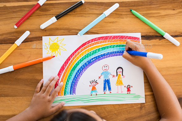 Child drawing happy family - Stock Photo - Images