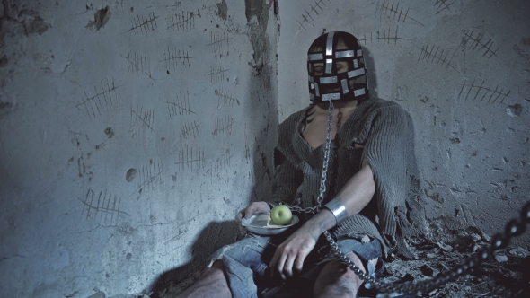 Prisoner in Chains Eats Food Brought alt