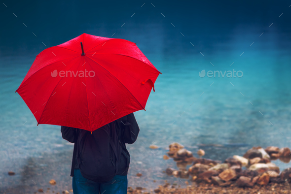 Due tidligere præmedicinering Woman with red umbrella contemplates on rain Stock Photo by stevanovicigor