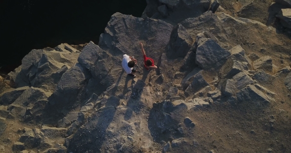 Son and Father on Rocky Cliff alt