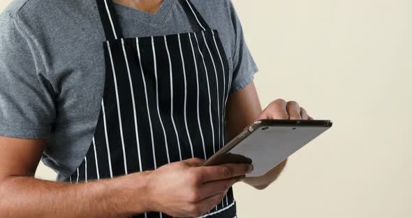 Smiling waiter standing using digital tablet 4K 4k alt