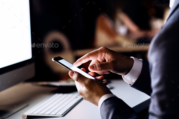 Unrecognizable businessman in the office at night. - Stock Photo - Images