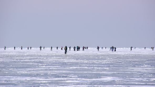 Group of Skiers and Cyclists Racing on Skis on the Snowy Ice.