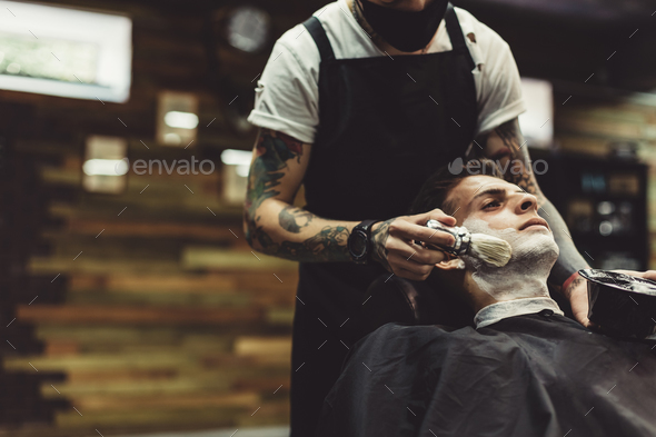 Barber shaving client - Stock Photo - Images