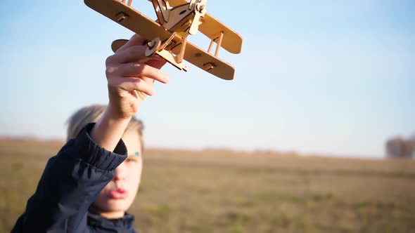 The Guy Holds a Plane in His Hand Simulates Flight alt