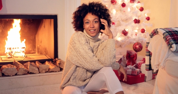 Woman By Fireplace and White Christmas Tree