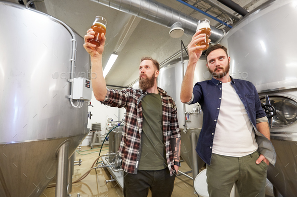 men testing non-alcoholic craft beer at brewery - Stock Photo - Images