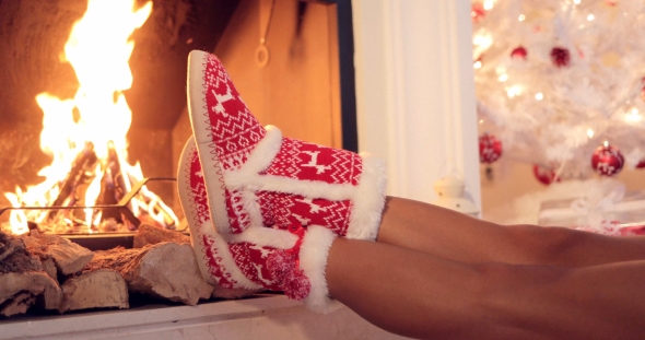 Young Woman Relaxing in Christmas Booties
