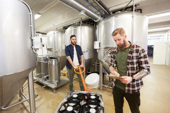 men with beer kegs on loader at craft brewery