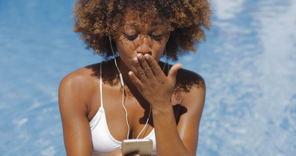 Charming Girl Using Phone in Pool alt