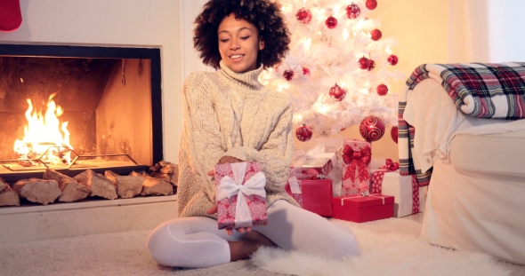 Pretty African American Woman Holds Christmas Gift