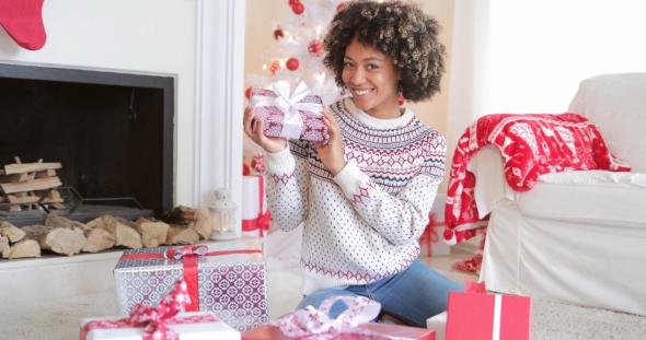 Pretty Young Woman Checking Her Christmas Gifts