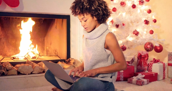 Chic Young Woman Typing a Christmas Message