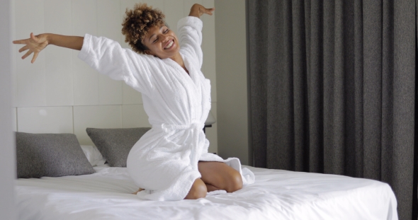 Excited Woman Posing on Bed alt