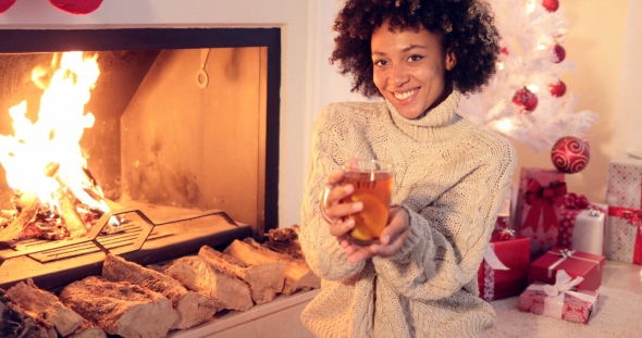 Happy Young Woman Relaxing at Christmas