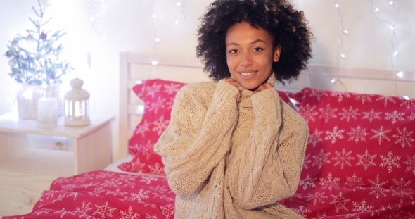 Pretty Young African Woman in a Christmas Bedroom