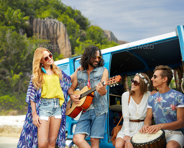 hippie friends playing music at minivan on beach
