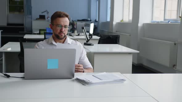 Man Looks on the Papersheets and Scratches His Horehead alt