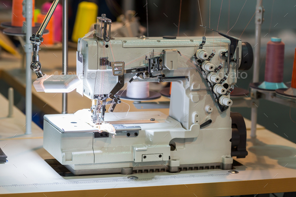 Sewing machine and cloth in cutting shop, nobody - Stock Photo - Images