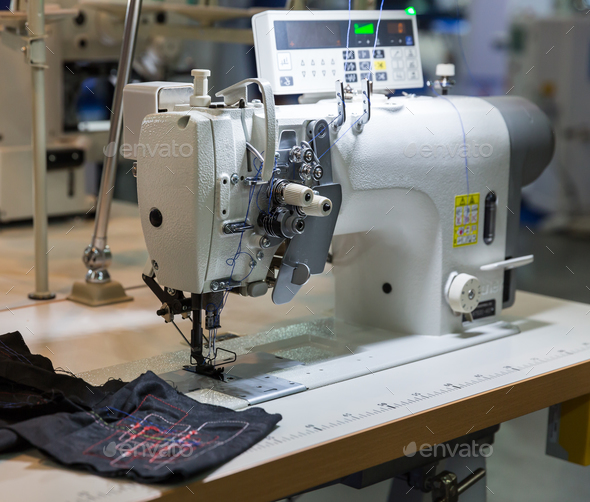 Sewing machine and cloth in cutting shop, nobody - Stock Photo - Images