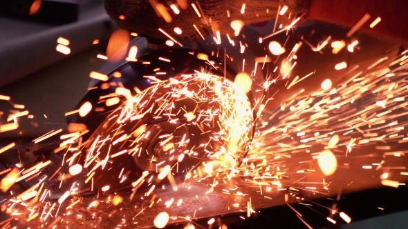 Cutting Metal with Disc Grinder with Bright Sparks