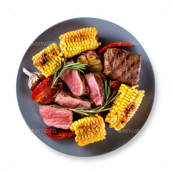 Round blue plate with pieces of chopped steak - Stock Photo - Images