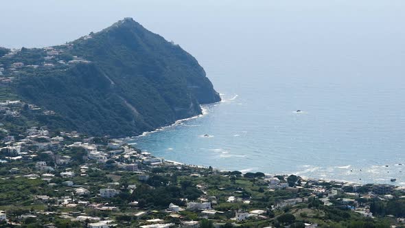 Aerial View of Rippled Blue Tyrrhenian Sea, Ischia Island Coastline, Sunny Day alt