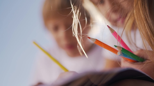 Little Boy and Girl Draw with Pencils