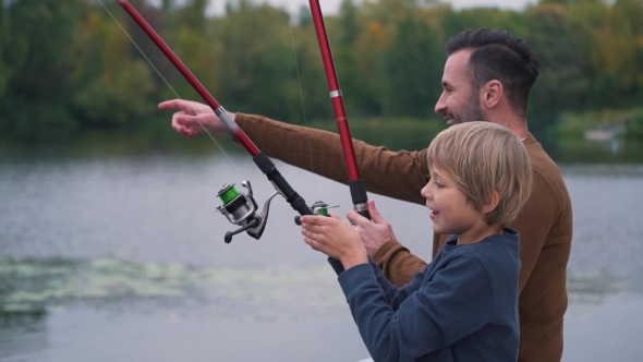 Happy Father with Son Are Fishing