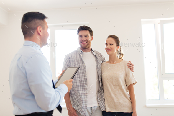 couple and realtor with tablet pc at new home