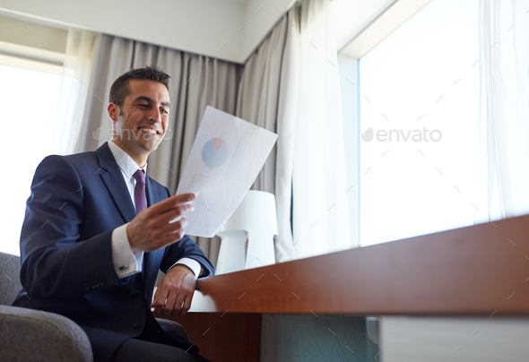 businessman with papers working at hotel room