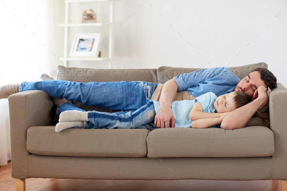 happy-father-and-son-sleeping-on-sofa-at-home-stock-photo-by-dolgachov