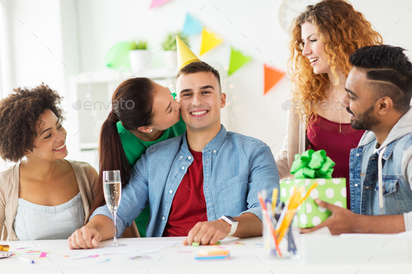 team greeting colleague at office birthday party