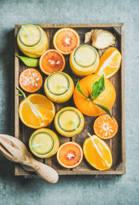 Healthy yellow smoothie in bottles with fresh fruits, top view - Stock Photo - Images