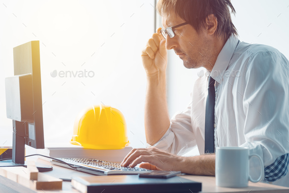 Architect and construction engineer working in office