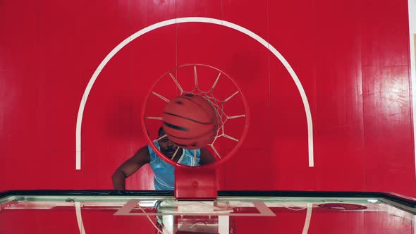 Top View of a Gym Basket with a Ball Getting Thrown Into It alt