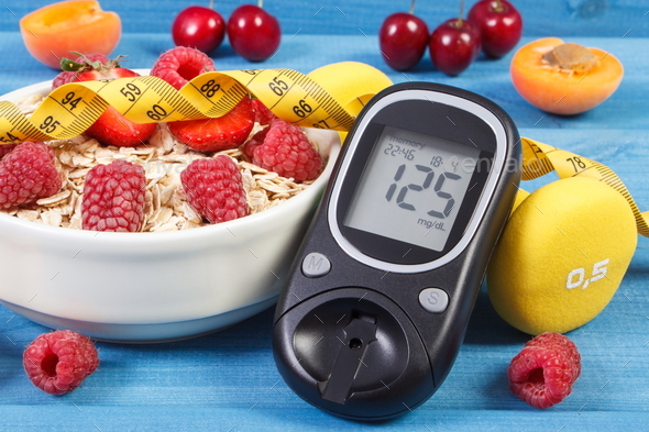 Glucose meter, oat flakes with fruits, dumbbells and centimeter