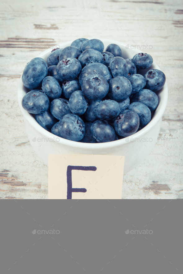 Fresh blueberries in bowl, natural source of vitamin E and minerals