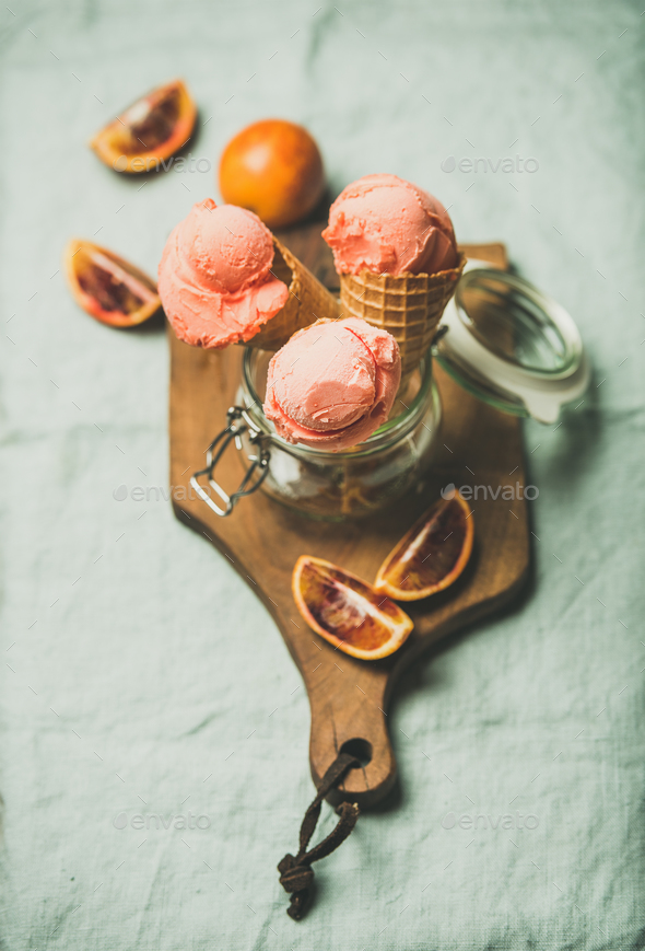 Refreshing summer blood orange ice cream on rustic wooden board - Stock Photo - Images