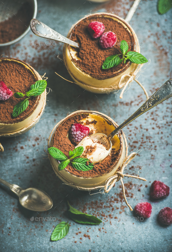 Homemade Tiramisu in glasses with raspberries and fresh mint leaves - Stock Photo - Images