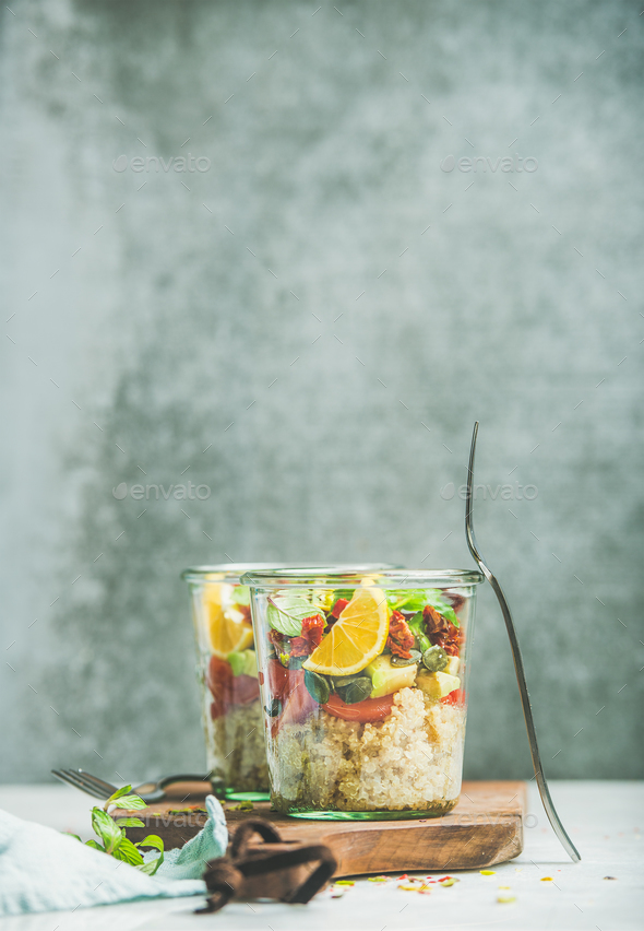 Healthy salad with quionoa, avocado, dried tomatoes, basil and orange - Stock Photo - Images