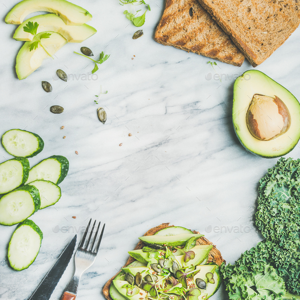 Sandwich with avocado, cucumber, kale, kress sprouts, pumpkin seeds - Stock Photo - Images