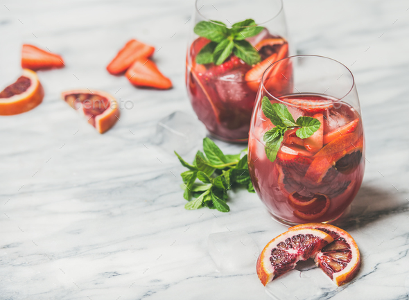 Fruit refreshing Sangria cocktails with ice cubes and fresh mint - Stock Photo - Images
