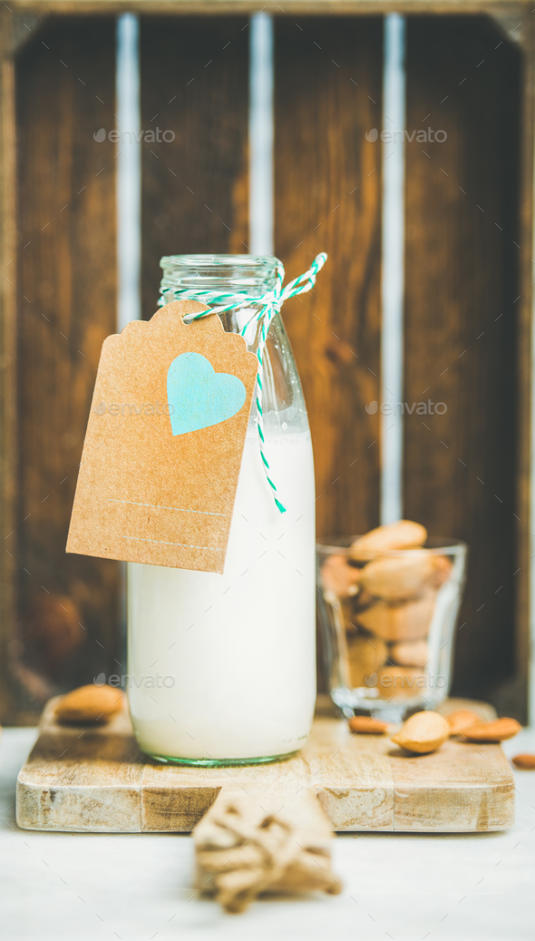 Fresh vegetarian dairy-free almond milk served with nuts - Stock Photo - Images