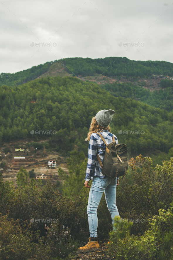 A Girl in Hiking Clothes Photographs Landscapes in the Mountains